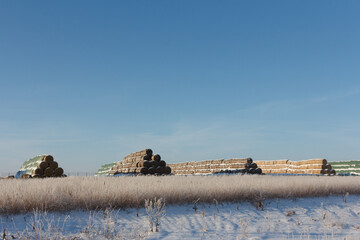 Haystacks in winter. Winter storage of hay. Rural landscape