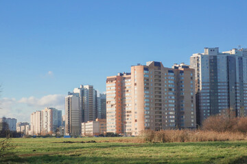 Cityscape: tall apartment buildings in a residential area of the city under the blue sky