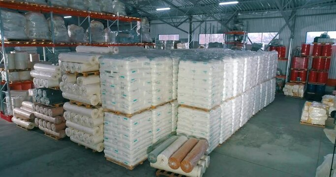 Warehouse of raw materials at the factory. Lots of raw material bag for production. Spunbond in rolls in the warehouse of the factory