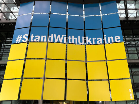 Berlin, Germany, March 2022 - A large banner in the national colors (national flag) of Ukraine hangs in the main hall of Berlin Central Station and  bears the slogan "#StandwithUkraine"