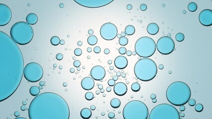 Blue oil drops floating in transparent fluid against pale blue background | Background for body care gel commercial shot