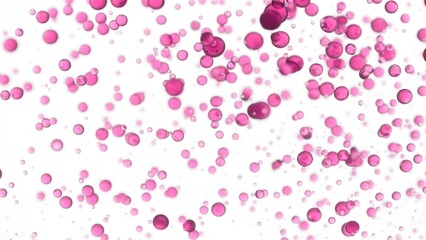 Rose oil is poured into the water creating a lot of different sized clear pink bubbles on white background | Abstract body care cosmetics with rose oil formulation concept