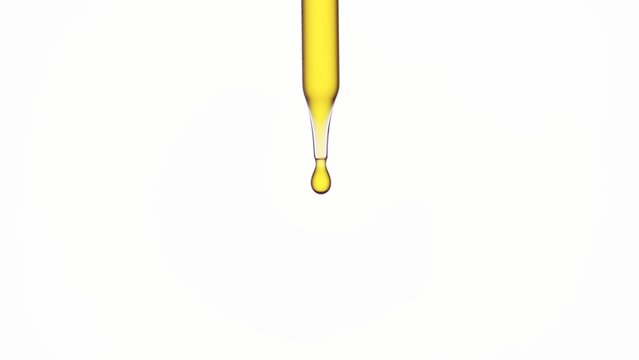 Macro shot of lab dropper with yellow oil on white background | Abstract skin care formulation concept