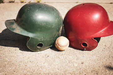 Baseball and batting helmet on ball field