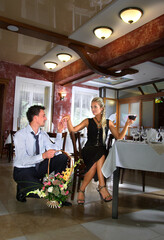 Couple in love in a restaurant. Declaration of love. Romantic meeting. Basket of flowers.