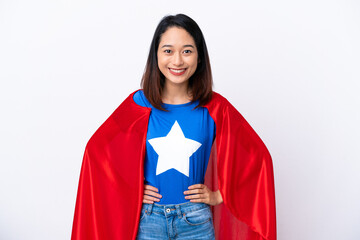 Young Vietnamese woman isolated on white background in superhero costume posing with arms at hip and smiling
