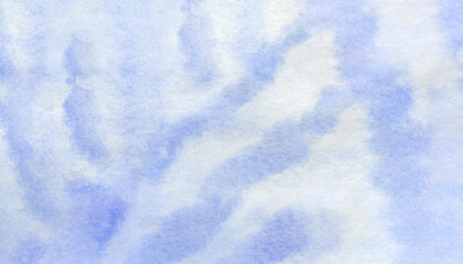 Blue watercolor streaks on paper, abstract painted background.