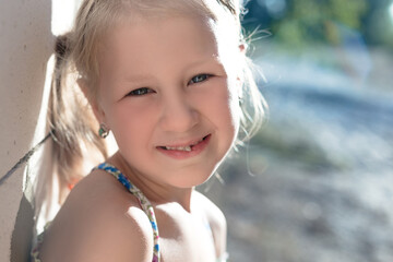 Portrait of a little girl with a wobbly baby tooth