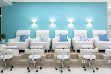 Nail salon interior, modern pedicure armchairs in manicure shop