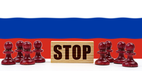 Against the background of the flag of Russia, pawns and a sign with the inscription - stop