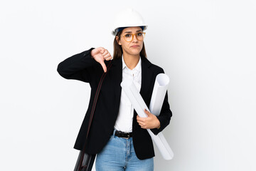 Young architect caucasian woman with helmet and holding blueprints over isolated background showing thumb down sign