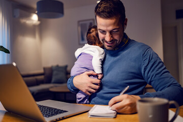 A super-dad multitasking from home, he babysits his daughter and finishing an online project.