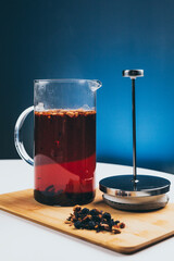 tea infuser set for making fruit tea on a white table in the background blue wall