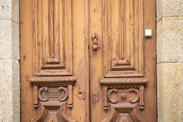 ancient door knocker, key lock and a mailbox on an antique brown wooden door