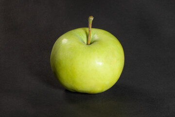 white apple on black background