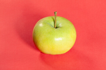 white apple on red background
