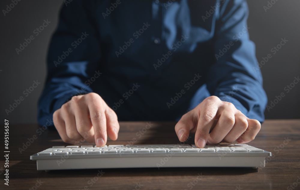 Poster male hands typing on computer keyboard.