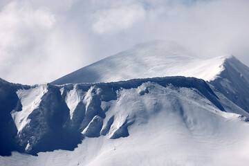 Fototapeta na wymiar Cloudy winter landscape in the Transylvanian Alps - Fagaras Mountains, Romania, Europe