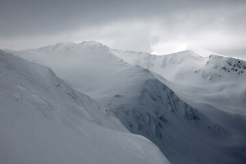 Fototapeta na wymiar Cloudy winter landscape in the Transylvanian Alps - Fagaras Mountains, Romania, Europe
