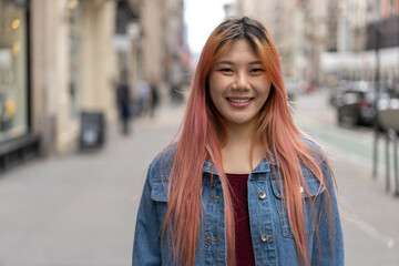 Fototapeta premium Young Asian woman with pink hair smile happy face portrait