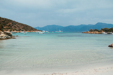 Fototapeta na wymiar Feet in the sand on a fine sand beach in Corsica located on the customs path 