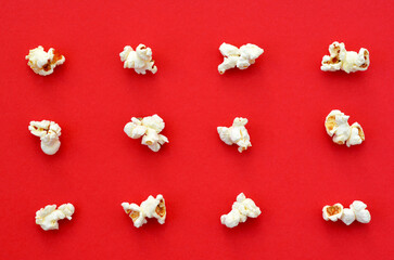 scattered popcorn on red background pattern