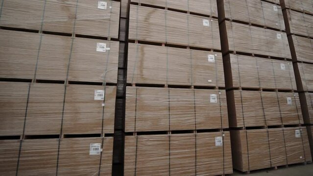 Stack of full size OSB chipboard pallets, ready to pick up by forklift.