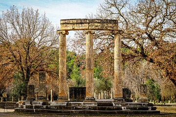 Reconstructed pillars of temple at ancient Olympia Greece  on rounded foundation in wintertime