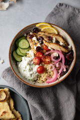 Healthy lunch bowl with greek chicken, feta and tzatziki