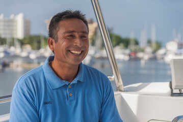 Portrait of a latin captain of a tour services boat smilling