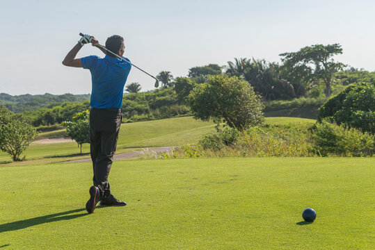 Latin golfer practicing his swing in the morning at the course