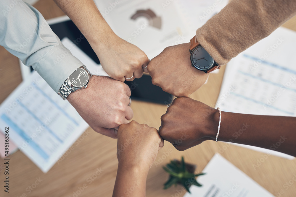 Poster we got this. high angle shot of an unrecognizable group of businesspeople huddled together with thei