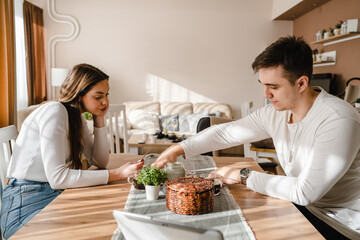 Two people man and woman young couple husband and wife brother and sister or boyfriend and girlfriend playing cards at home in bright day real people leisure games concept having fun copy space