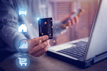 Businessman holding a credit card and using a smartphone to make mobile payments on online shopping website with laptop computer, payment communication network, Credit card for online transactions.