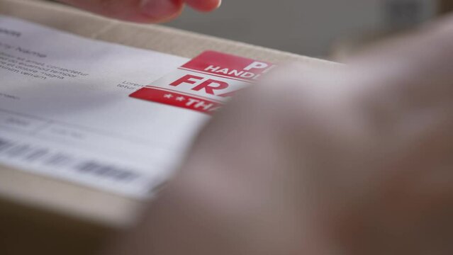 Closeup view of female online store small business owner entrepreneur packing package post shipping box preparing delivery parcel on table. Ecommerce dropshipping shipment service concept.