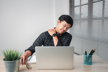 Asian business men are suffering from work-related pain from office syndrome