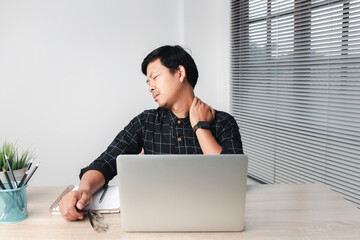 Fototapeta premium Asian business men are suffering from work-related pain from office syndrome