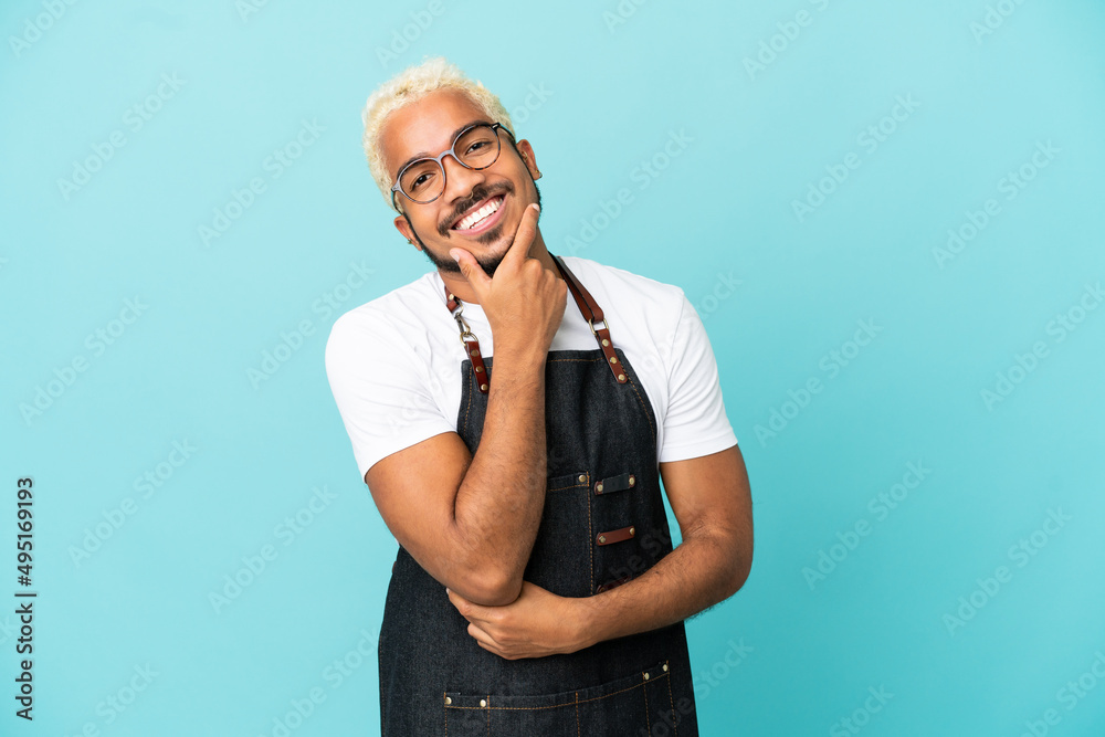 Sticker restaurant colombian waiter man isolated on blue background smiling