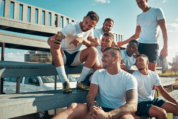 Were trending online guys. Shot of a rugby player showing his teammates something on his cellphone.