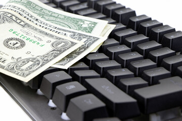 Dollars, banknotes and black keyboard isolated on a white background. Work at home. Make maoney.Select focus
