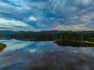 Sunrise reflections and clouds at the seaside with lagoon