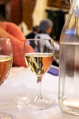 Italian white house wine served in pitcher with two glasses for dinner