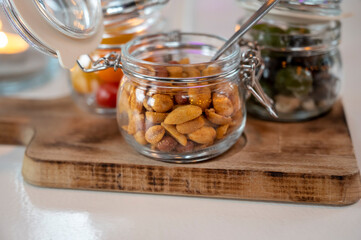 Glass jars with healthy party snacks served in bar, tasty appetisers