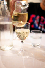 Italian white house wine served in pitcher with two glasses for dinner