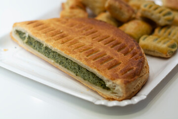 Fresh baked pastry pie stuffed with green spinach in small bakery in Parma, Emilia Romagna, Italy