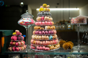 Candy shop display with colorful pyramid of French macarons biscuits
