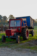Naklejka premium Old vintage tractors in early morning sunlights on cheese farm in Italy