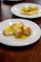 Tasting of Italian extra virgin olive oil with bread on organic farm in Tuscany, Italy