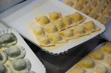 Italian food, fresh home made stuffed pasta tortelli or ravioli dumplings ready to cook, Parma, Emilia Romagna, Italy