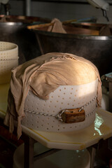 Process of making wheels of parmigiano-reggiano parmesan cheese on small cheese farm in Parma, Italy